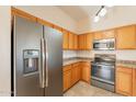 Well-equipped kitchen with stainless steel refrigerator, microwave, and range at 320 N 168Th Dr, Goodyear, AZ 85338