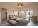 Inviting living room with a cozy seating arrangement and sliding doors to the balcony at 320 N 168Th Dr, Goodyear, AZ 85338