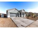 Well-maintained home with desert landscaping, a two-car garage, and covered front porch at 3923 S 244Th Dr, Buckeye, AZ 85326