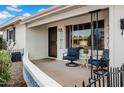 Inviting front porch with seating, perfect for enjoying the neighborhood views at 6329 E Dodge St, Mesa, AZ 85205