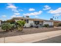 A well landscaped front yard with desert plants and decorative rocks enhances this home's curb appeal at 6329 E Dodge St, Mesa, AZ 85205