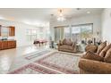 Spacious living room featuring large windows, tile flooring, neutral walls, and elegant furnishings at 6336 S Granite St, Gilbert, AZ 85298