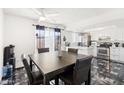 Contemporary dining area with stylish table and chairs, adjacent to a well-equipped, bright, modern kitchen at 6345 N 49Th Ave, Glendale, AZ 85301