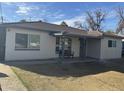 Charming single-story home with a covered front porch and a cozy seating area at 6532 N 60Th N Ave, Glendale, AZ 85301