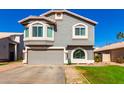 Charming two-story home featuring a well-manicured lawn and a spacious driveway at 7456 E Milagro Ave, Mesa, AZ 85209