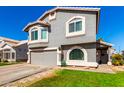 Charming two-story home featuring a well-manicured lawn and a spacious driveway at 7456 E Milagro Ave, Mesa, AZ 85209