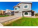 Charming two-story home featuring a well-manicured lawn and a spacious driveway at 7456 E Milagro Ave, Mesa, AZ 85209