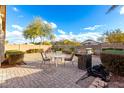 The backyard boasts a stone-paved area with patio furniture, perfect for outdoor relaxation and dining at 757 E Lovegrass Dr, San Tan Valley, AZ 85143