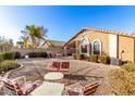 The backyard offers a tranquil space with gravel, patio furniture, and well-maintained landscaping at 757 E Lovegrass Dr, San Tan Valley, AZ 85143