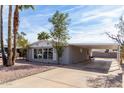 Residential building with covered parking, rock landscaping and palm trees at 7645 E Gale Ave, Mesa, AZ 85209