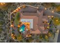 Aerial view of backyard oasis with sparkling pool, spa, covered patio, and impeccably maintained tile roof at 8320 E Arroyo Hondo Rd, Scottsdale, AZ 85266