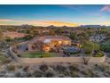 Stunning backyard featuring a pool, spa, patio, and lush landscaping with beautiful desert views at 8320 E Arroyo Hondo Rd, Scottsdale, AZ 85266