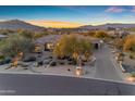 Attractive single-story home featuring desert landscaping, a paver driveway, and mountain views at 8320 E Arroyo Hondo Rd, Scottsdale, AZ 85266