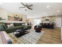 Inviting living room with a comfortable sectional sofa, ceiling fan, and seamless transition to the kitchen at 8640 E Dianna Dr, Scottsdale, AZ 85257