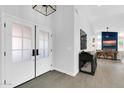 Elegant entryway featuring double doors, tile flooring, and a clear view into the open-concept living space at 9739 E Pershing Ave, Scottsdale, AZ 85260