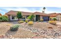 Striking exterior featuring desert landscaping, a tile roof, and a stone lined dry creek bed for optimal drainage at 9739 E Pershing Ave, Scottsdale, AZ 85260