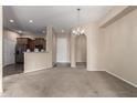 Open-concept living area with views of the kitchen, providing a spacious and airy feel to the home at 14575 W Mountain View Blvd # 11221, Surprise, AZ 85374