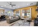 Bright living room boasts a ceiling fan, neutral tones, and a sliding glass door that fills the space with natural light at 1531 S Owl Dr, Gilbert, AZ 85296