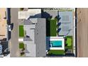 Bird's-eye view showcases a stunning property with a pool, sports court, modern architecture, and manicured landscaping at 16832 E Hazeltine Way, Queen Creek, AZ 85142