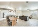 Bright, open-concept living and dining area with wood-look flooring, high ceilings, and natural light at 17132 N Silver Path, Surprise, AZ 85374