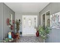 A welcoming covered entryway featuring a decorative door with sidelights and stylish decor at 18614 N Conestoga Dr, Sun City, AZ 85373