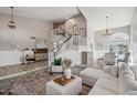 Spacious living room with high ceilings, wood flooring and a staircase at 19240 N 90Th Pl, Scottsdale, AZ 85255