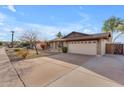 Well-maintained single-story home with brick facade, two-car garage, and mature landscaping at 2447 E La Jolla Dr, Tempe, AZ 85282