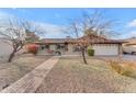 Charming single-story home with brick facade, manicured landscaping, and a welcoming walkway at 2447 E La Jolla Dr, Tempe, AZ 85282