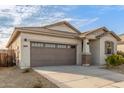Well-kept single-story home with a two-car garage, desert landscaping, and a welcoming front entrance at 25610 N 144Th Ln, Surprise, AZ 85387