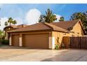 Spacious three-car garage offers ample parking and storage space at the end of a driveway at 265 E Liberty Ln, Gilbert, AZ 85296