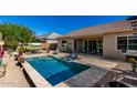 Inviting backyard pool and covered outdoor dining area, perfect for relaxing and entertaining at 3202 N 197Th Ave, Buckeye, AZ 85396
