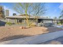 Inviting single-story home with desert-style landscape, with a xeriscaped front yard, and a convenient two-car garage at 3834 E Shaw Butte Dr, Phoenix, AZ 85028