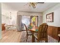 Cozy dining area with wood floors, a round wooden table, and a ceiling fan at 459 S Boojum Way, Mesa, AZ 85208