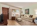 Inviting living room featuring a sofa, patterned rug, and a wooden front door at 459 S Boojum Way, Mesa, AZ 85208