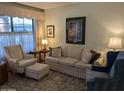 Cozy living room featuring neutral-toned furniture, soft lighting, and a large window at 459 S Boojum Way, Mesa, AZ 85208