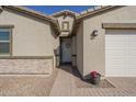 Close up of the front entrance with a decorative wreath, stylish door, and stone accents at 4878 W Elijah Ln, San Tan Valley, AZ 85144