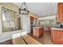 Open kitchen featuring stainless steel appliances, an island, and warm lighting perfect for cooking and entertaining at 5040 E Robin Ln, Phoenix, AZ 85054