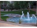 Beautiful water fountain in a community park, surrounded by a grassy area at 5345 E Van Buren St # 167, Phoenix, AZ 85008