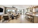 Open-concept layout with living room, dining area and kitchen with a large sectional, stylish chairs, and modern decor at 5719 S Quartz St, Gilbert, AZ 85298