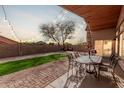 Inviting backyard patio with string lights, green grass, and beautiful outdoor furniture at 6965 E Hacienda La Noria Ln, Gold Canyon, AZ 85118