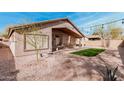 Expansive backyard featuring desert landscaping, a covered patio, and a paved walkway for outdoor enjoyment at 6965 E Hacienda La Noria Ln, Gold Canyon, AZ 85118