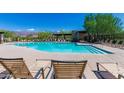 Inviting community pool with lounge chairs, surrounded by desert landscaping and mountain views at 6965 E Hacienda La Noria Ln, Gold Canyon, AZ 85118