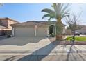 Desert home featuring a large three-car garage and drought-resistant landscaping at 9 W Glenhaven Dr, Phoenix, AZ 85045