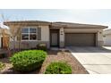 Charming single-story home featuring a well-kept front yard and two-car garage at 1039 W Tuli Way, San Tan Valley, AZ 85143