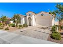 Inviting single-story home with a paved driveway, two-car garage, desert landscaping, and neutral colors at 11807 W Parkway Ln, Avondale, AZ 85323