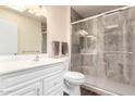 Updated bathroom with a glass shower enclosure, and a sleek vanity with a white countertop at 13621 N Emberwood Dr, Sun City, AZ 85351