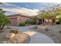 Exterior view of home featuring desert landscaping, stone accents, and a two-car garage at 15131 W Daybreak Dr, Surprise, AZ 85374