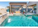 A luxurious pool and spa area with a pergola, creating an inviting oasis for relaxation and enjoyment at 17496 W Summit Dr, Goodyear, AZ 85338