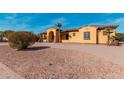 Attractive exterior with a tile roof, paved driveway, and desert landscaping, complemented by unique decorative touches at 18332 W Latham St, Goodyear, AZ 85338