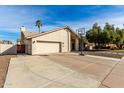 Charming single-story home with neutral stucco, two car garage, and a basketball hoop in the driveway at 1938 E Myrna Ln, Tempe, AZ 85284